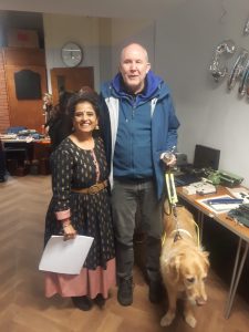 Image of Paul, Pyrgo and Manisha smilingfor a photo holding braille equipment