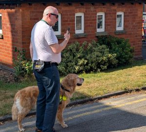 Image of Paul and Pyrgo, Paul is using his phone to notify him of obstacles